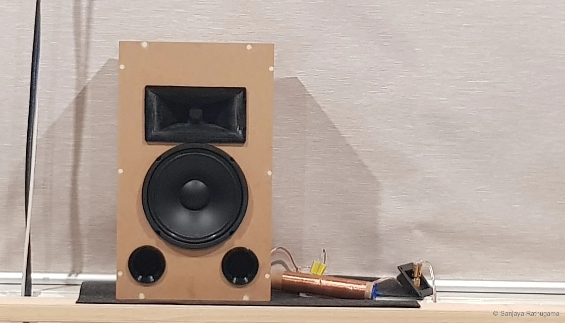 The 8-inch horn-loaded speaker prototype with temporary crossover components beside it