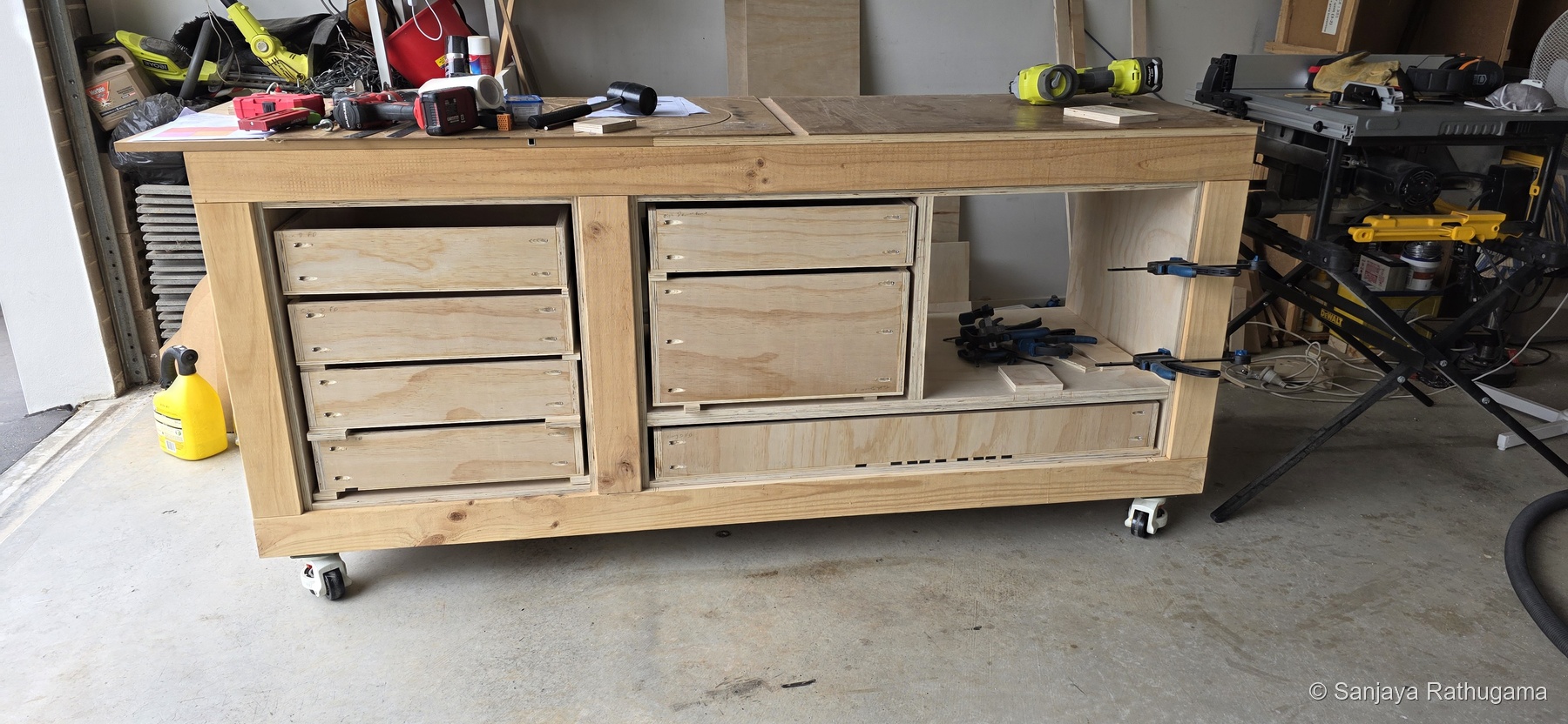 Seven fully assembled drawer boxes without fascias, temporarily positioned in the carcasses before mounting on runners