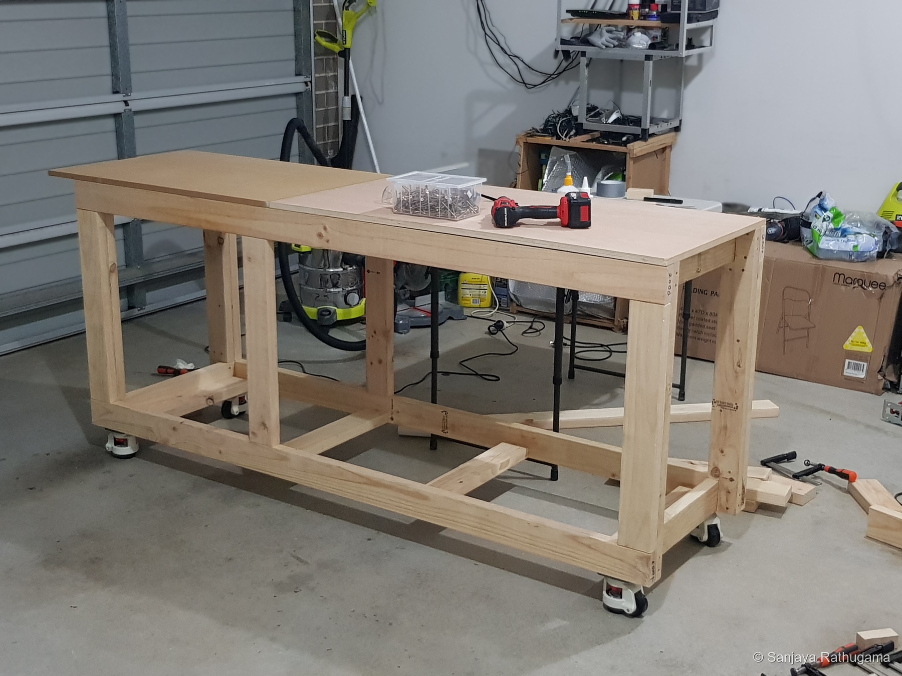 The newly assembled open pine workbench on castors