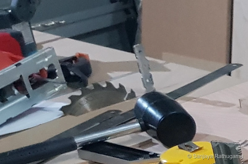 Close-up of the circular-saw blade projecting through the saw-side benchtop
