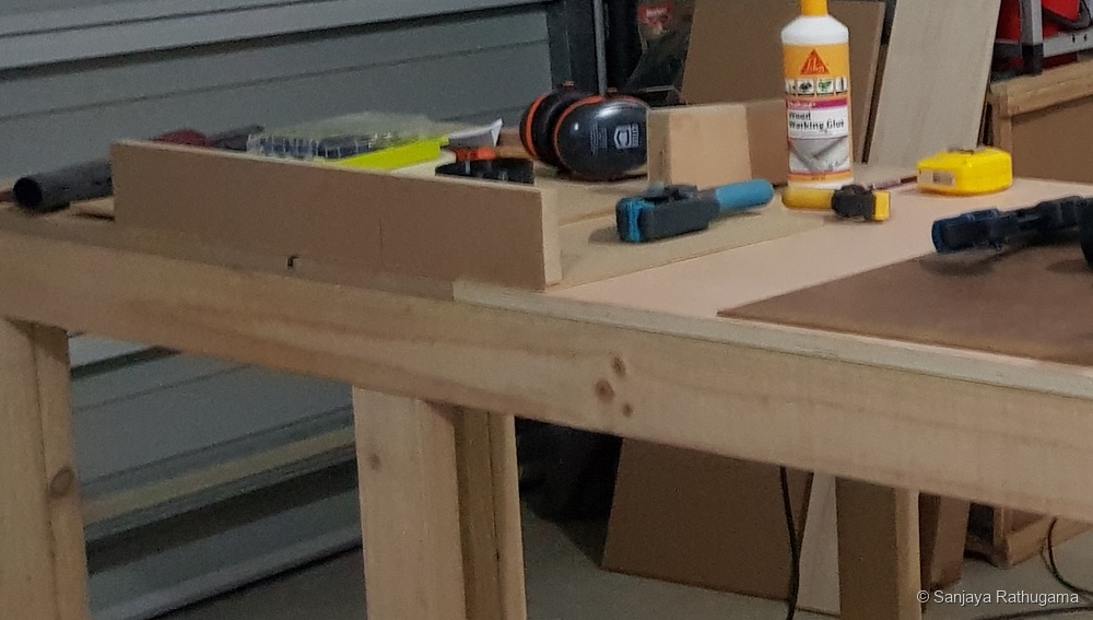 Close-up showing the saw tray, aluminium U-channel opening and MDF blade-cover box