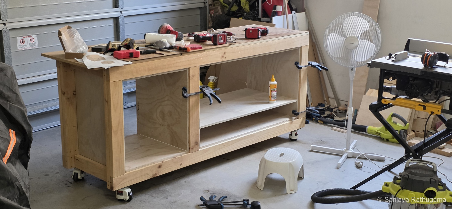 Plywood carcasses and partitions being installed beneath the bench