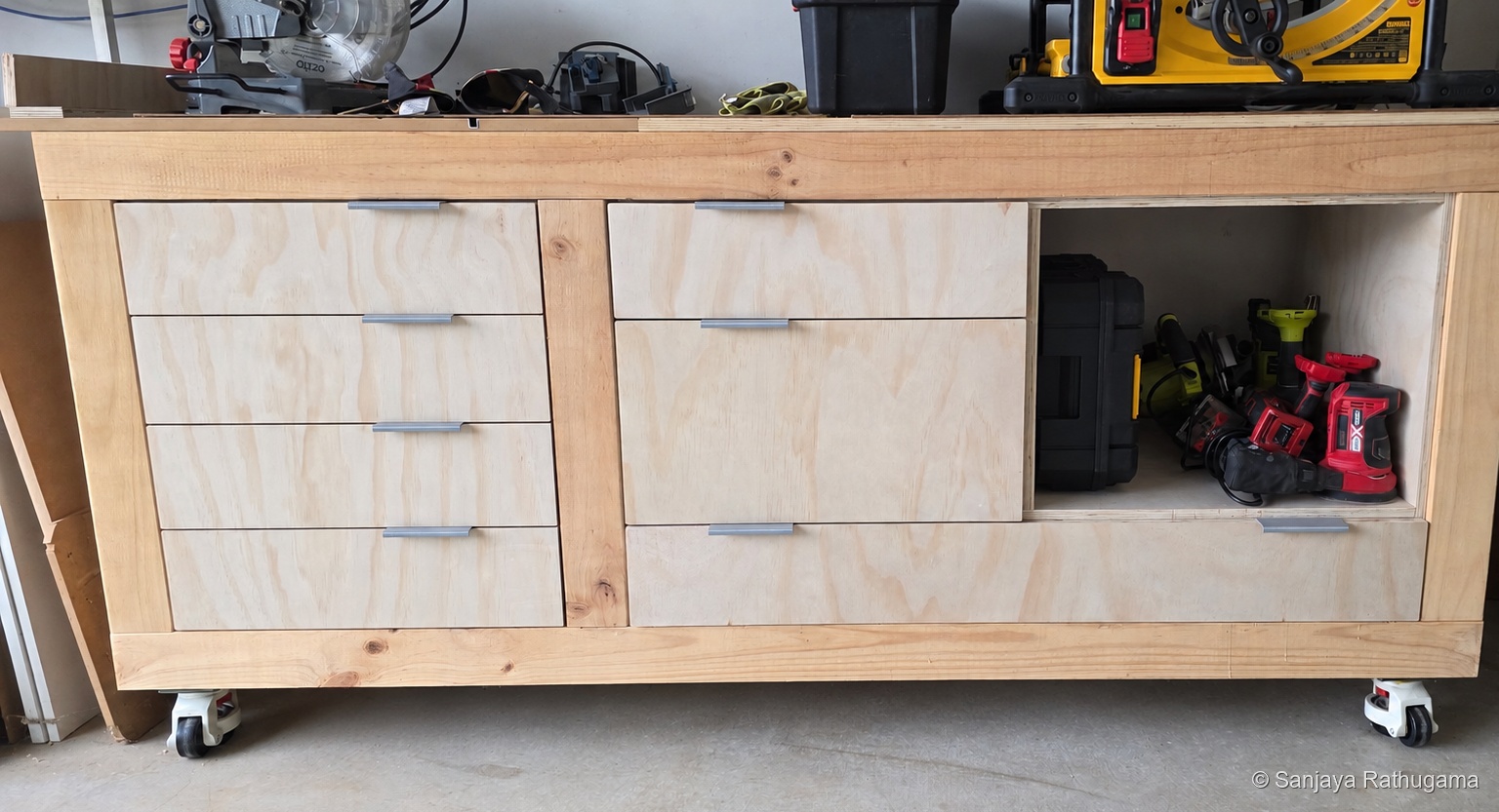 Garage workbench with fitted drawers and an open cupboard bay